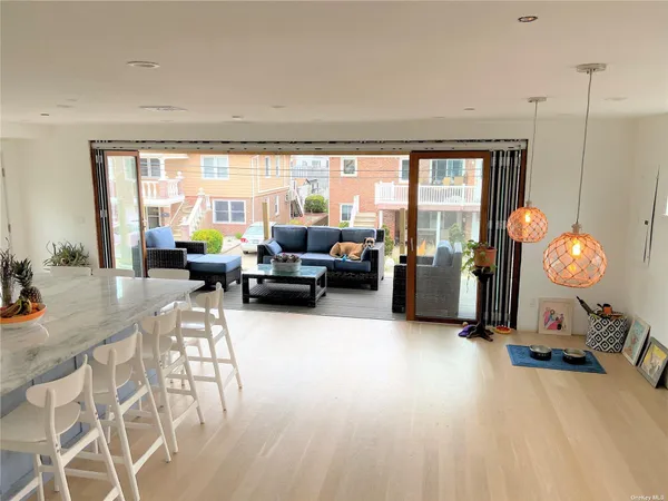 a living room with furniture floor to ceiling window and a table