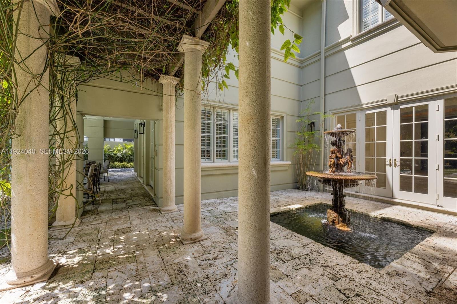 3460 South Moornings Way Miami, FL 33133 - Photo 16 of 29 a porch with a bench and floor to ceiling window