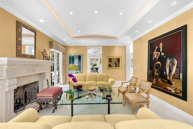 a living room with furniture potted plant lamp and a fireplace
