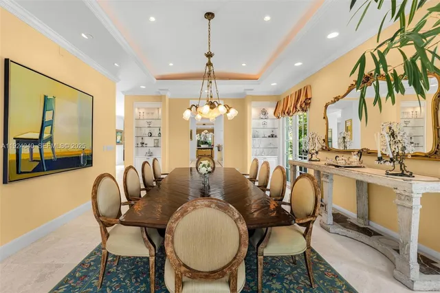 a dining room with furniture a chandelier and window