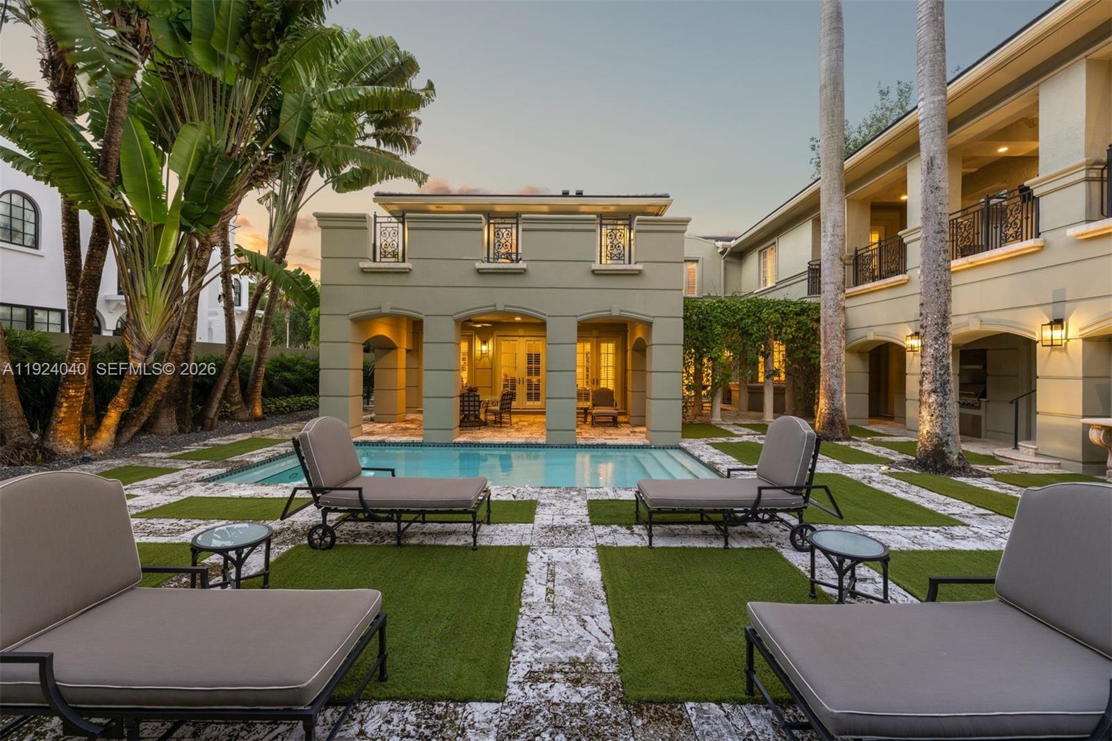 3460 South Moornings Way Miami, FL 33133 - Photo 24 of 29 a view of a patio with couches table and chairs potted plants and large tree
