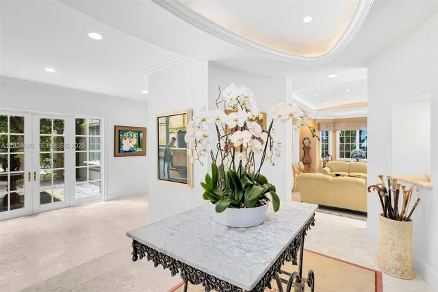 a dining room with furniture and potted plants