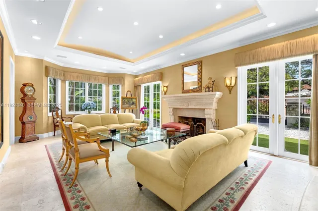 a living room with fireplace furniture and a large window
