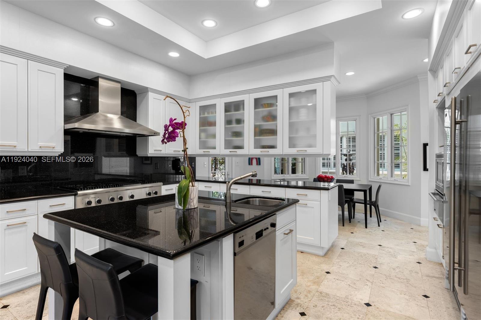 3460 South Moornings Way Miami, FL 33133 - Photo 6 of 29 a kitchen with granite countertop a sink stove and refrigerator