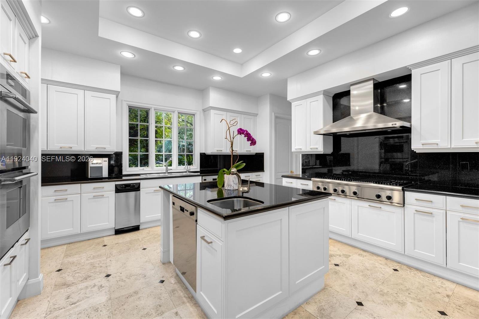 3460 South Moornings Way Miami, FL 33133 - Photo 7 of 29 a kitchen with stainless steel appliances granite countertop a sink stove and cabinets