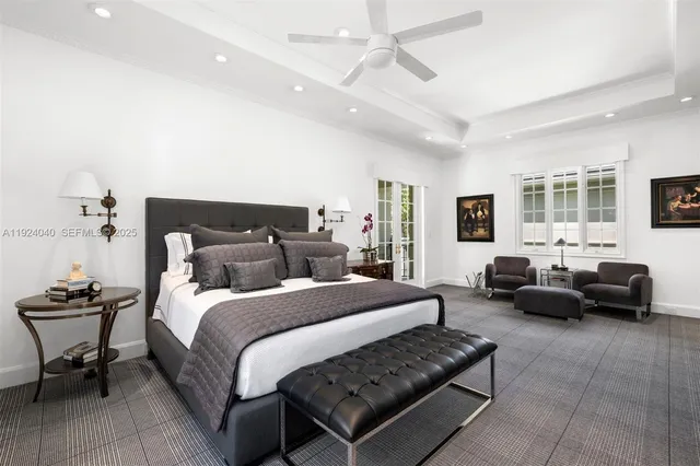 a bedroom with bed couch and window