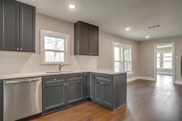 a kitchen with sink cabinets and window