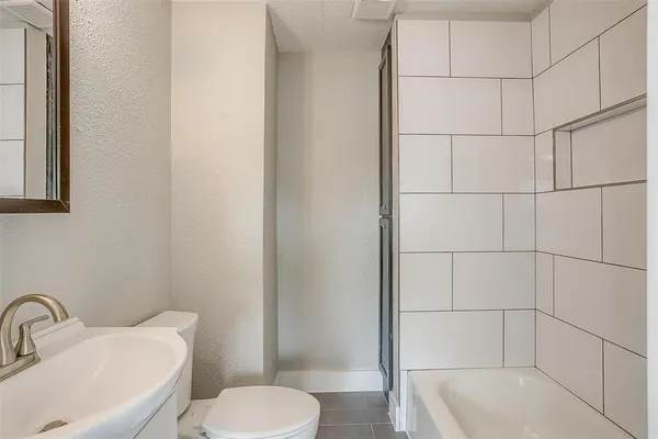 a white toilet sitting next to a bathroom sink
