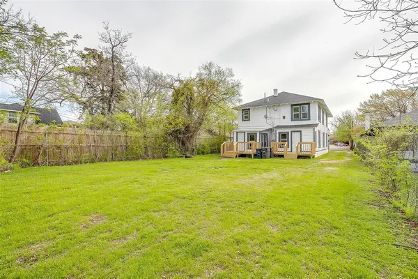 a front view of a house with a big yard
