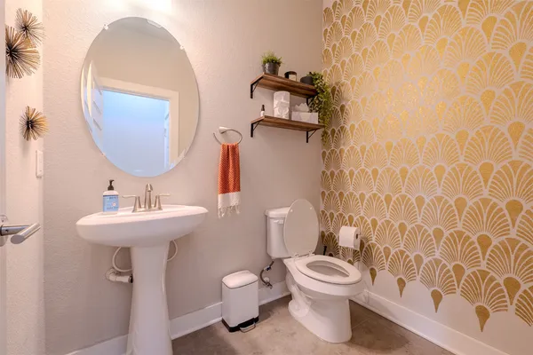 a bathroom with a toilet a sink and a mirror