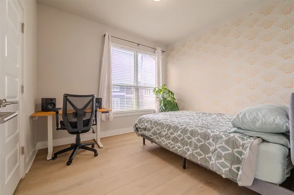 a bedroom with a bed chair and a window