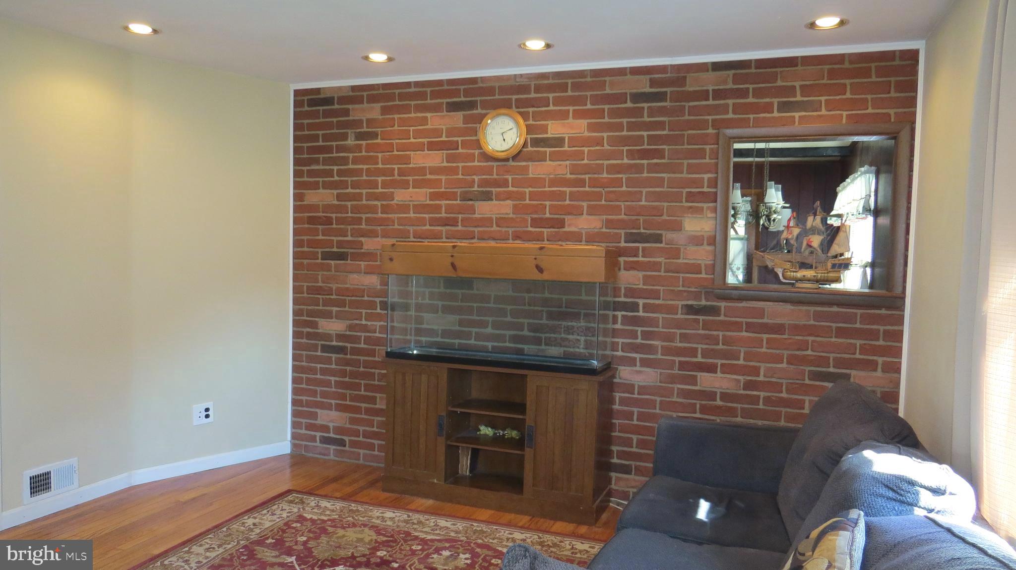 7608 Gum Road Dundalk, MD 21222 - Photo 3 of 46 Brick feature wall in living room
