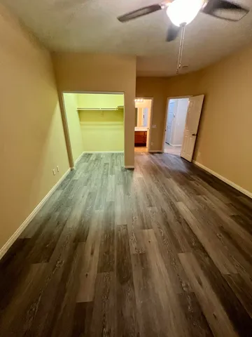 a view of empty room with wooden floor