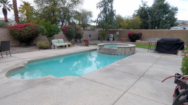 a view of a patio with chairs and plants