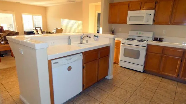 a kitchen with a sink stove and cabinets