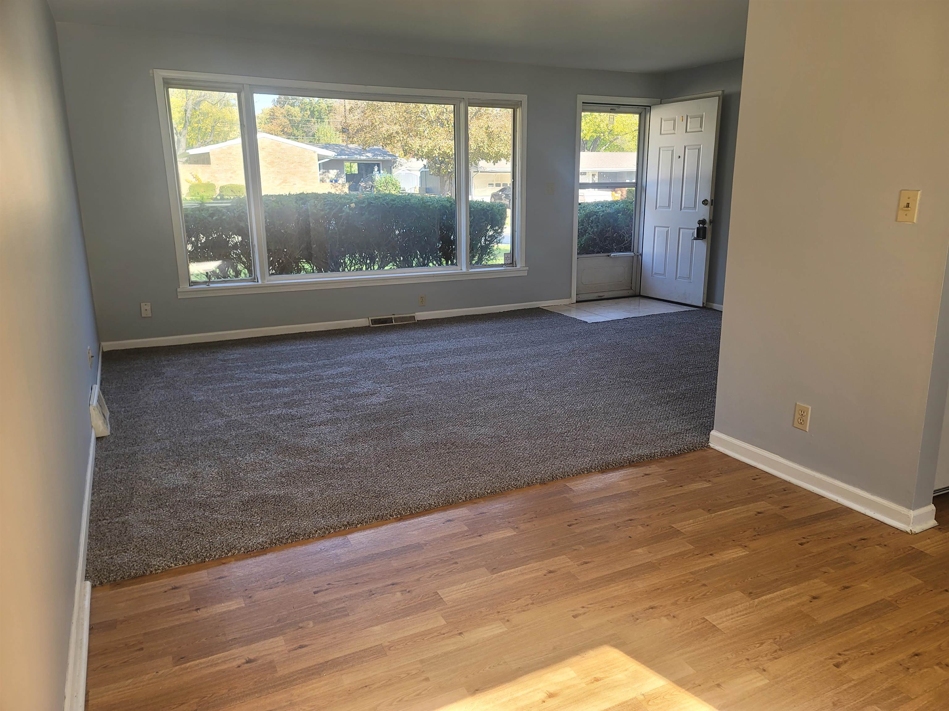 4807 Highcrest Road Rockford, IL 61107 - Photo 2 of 18 an empty room with large windows