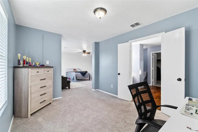 a room with a window and a dresser in it