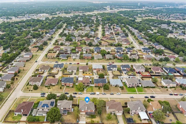 an aerial view of residential houses with outdoor space
