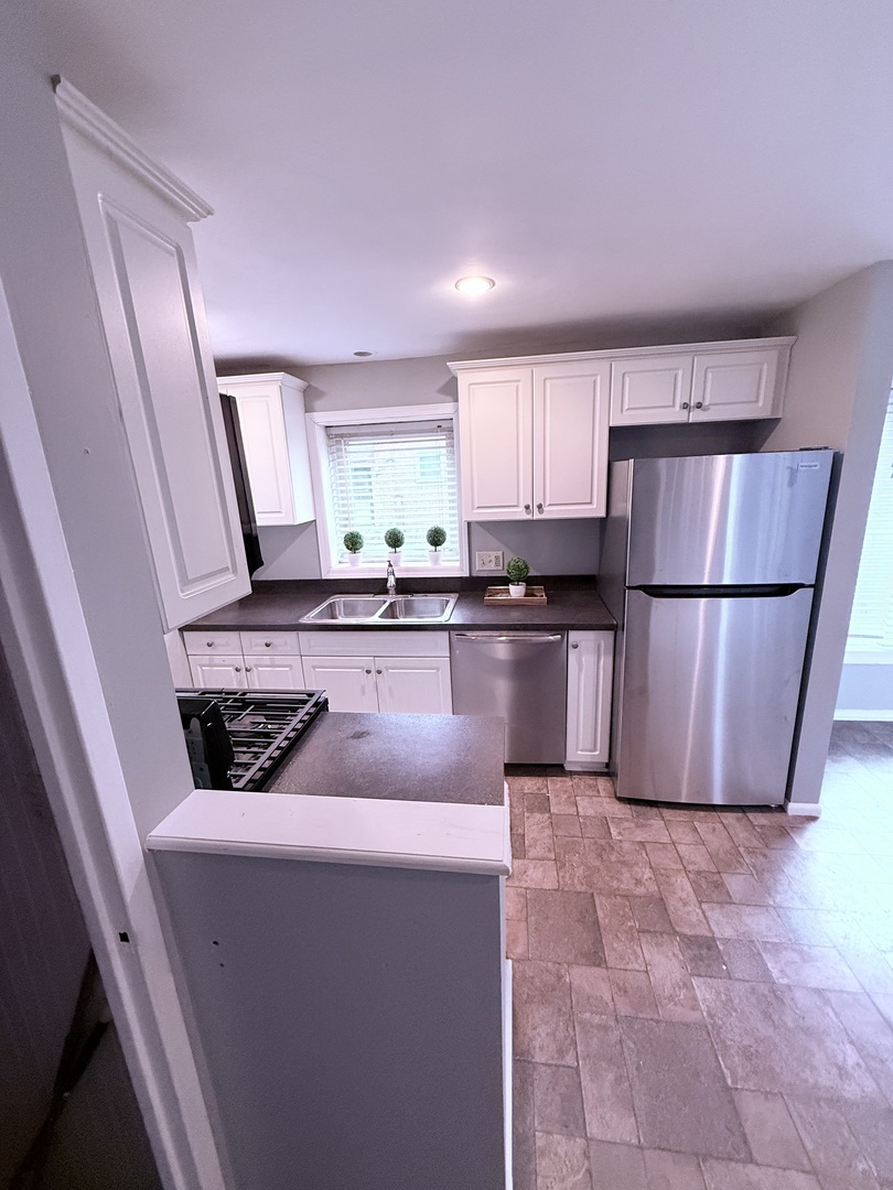 32 Dunlap Road Park Forest, IL 60466 - Photo 6 of 11 a kitchen with stainless steel appliances granite countertop a refrigerator sink and cabinets