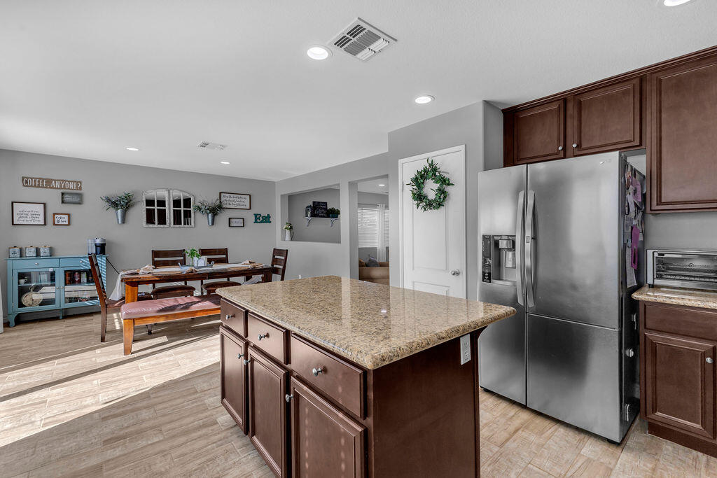 84285 Tramonto Way Indio, CA 92203 - Photo 14 of 63 a kitchen with stainless steel appliances granite countertop a refrigerator and a stove top oven