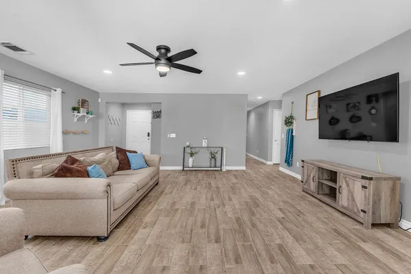 a living room with furniture and a flat screen tv