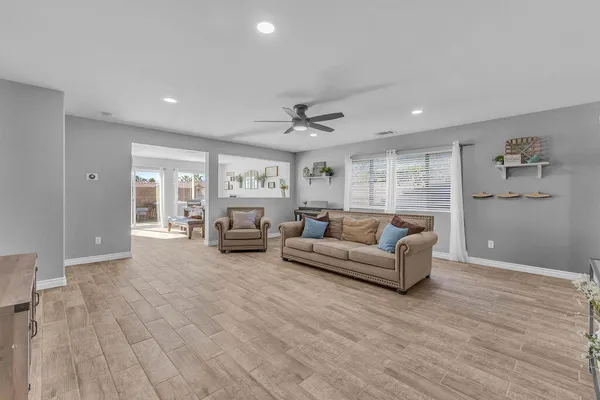 a living room with furniture and a wooden floor