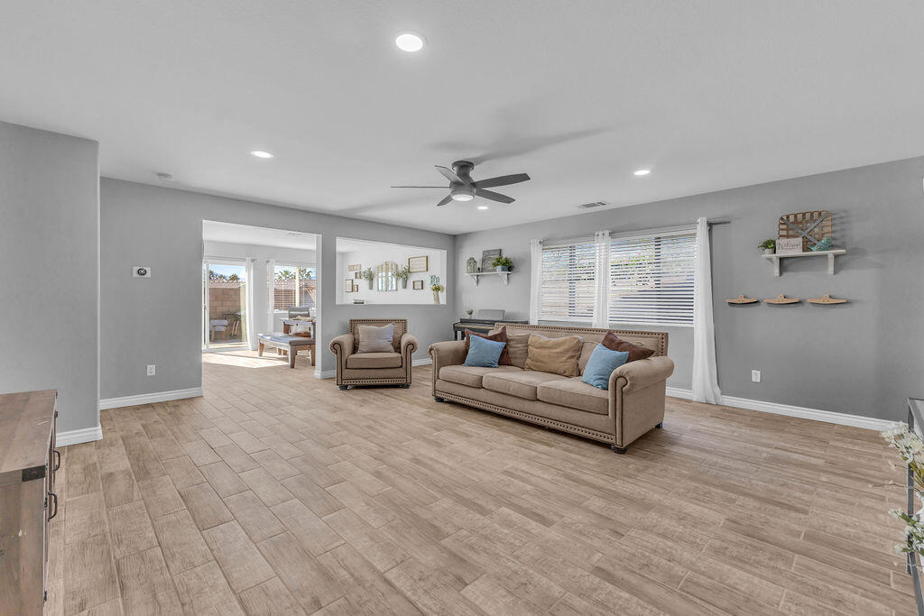 84285 Tramonto Way Indio, CA 92203 - Photo 8 of 63 a living room with furniture and a wooden floor