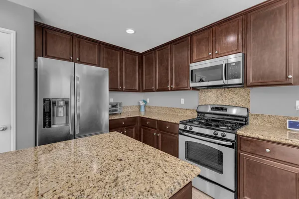 a kitchen with a refrigerator stove and microwave