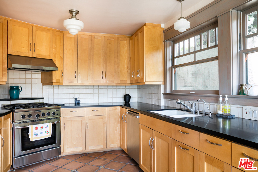 239 West Channel Road Santa Monica, CA 90402 - Photo 12 of 30 a kitchen with a sink cabinets and window