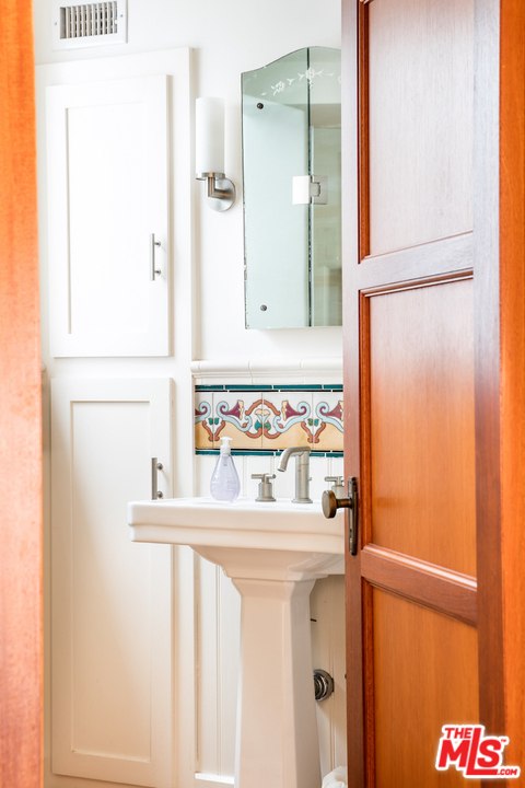 239 West Channel Road Santa Monica, CA 90402 - Photo 14 of 30 a bathroom with a sink and a mirror