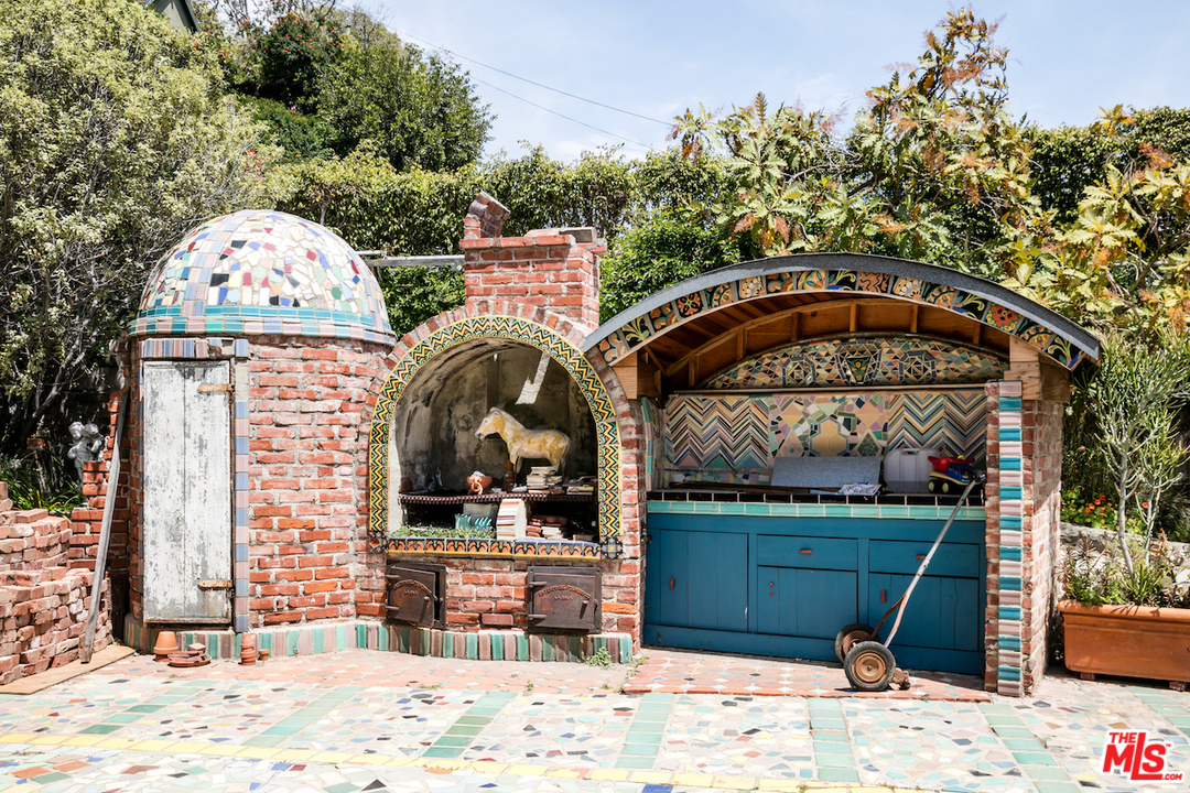 239 West Channel Road Santa Monica, CA 90402 - Photo 23 of 30 a view of a wooden door and a bench in the patio