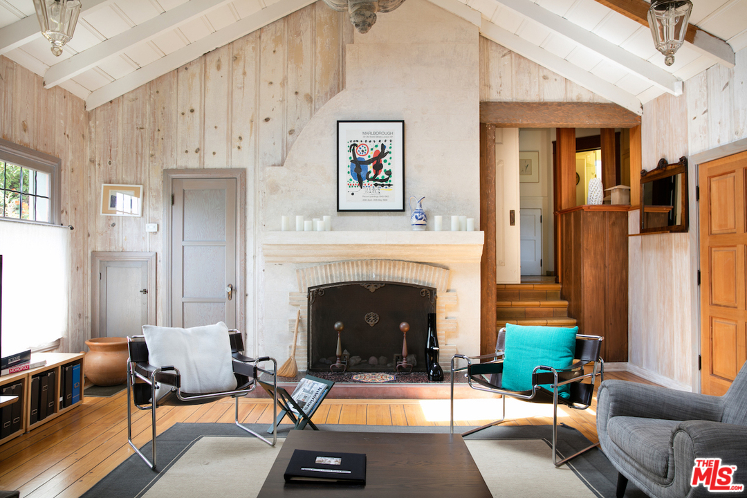 239 West Channel Road Santa Monica, CA 90402 - Photo 4 of 30 a living room with furniture and a fireplace