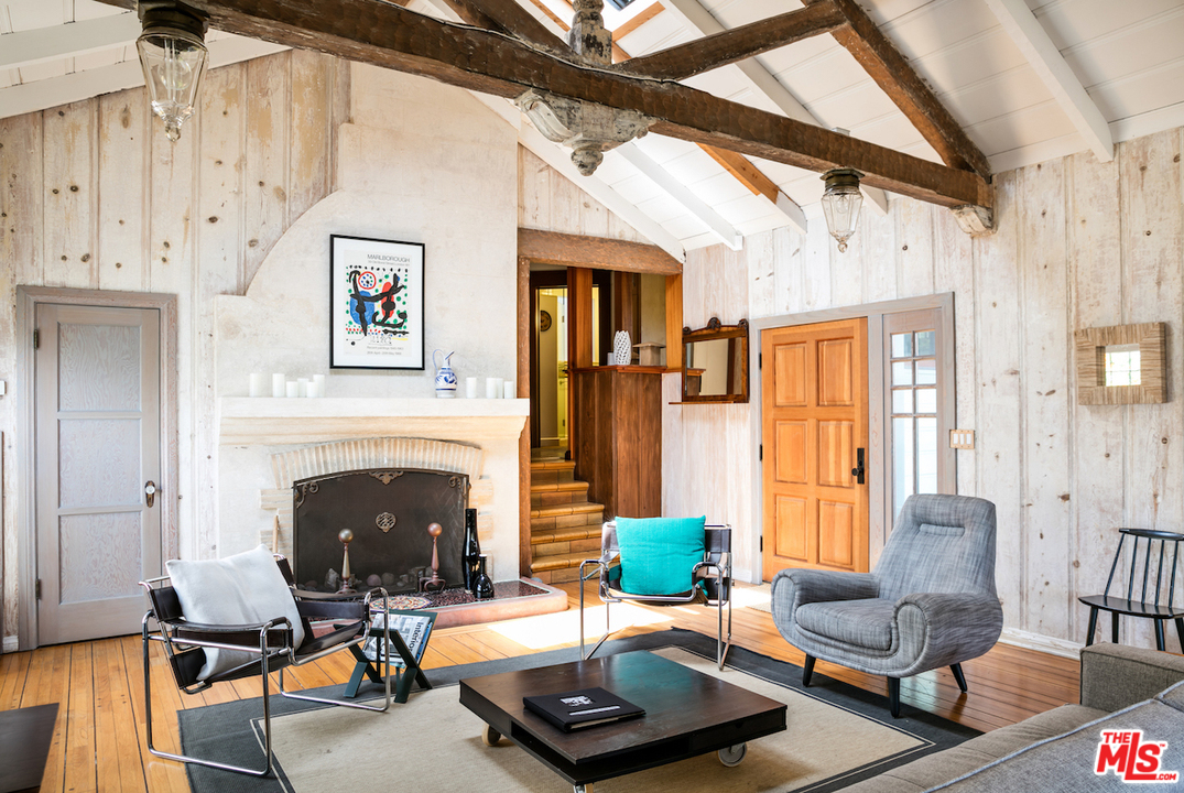 239 West Channel Road Santa Monica, CA 90402 - Photo 5 of 30 a living room with furniture and a fireplace