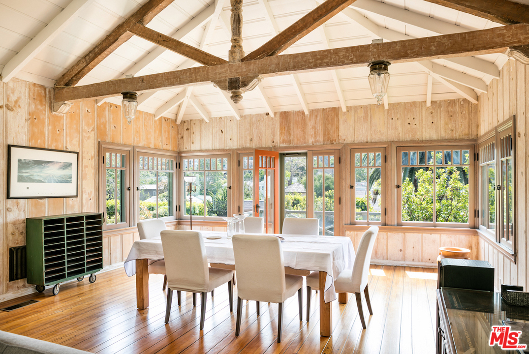 239 West Channel Road Santa Monica, CA 90402 - Photo 7 of 30 a view of a dining room with furniture a chandelier and wooden floor