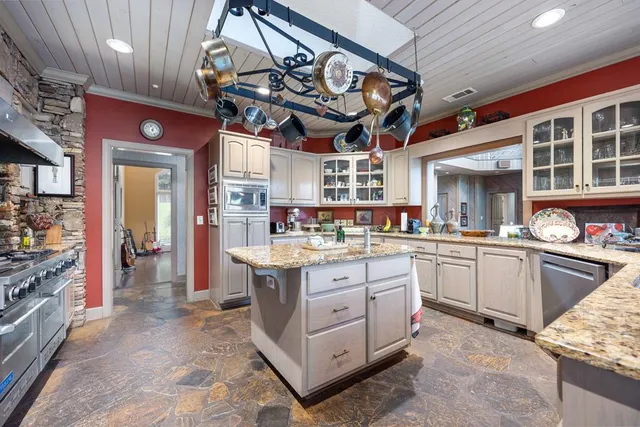 a spacious bathroom with a bathtub and a large window
