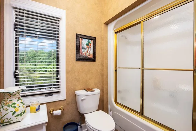 a view of a dirt road with trees in the background