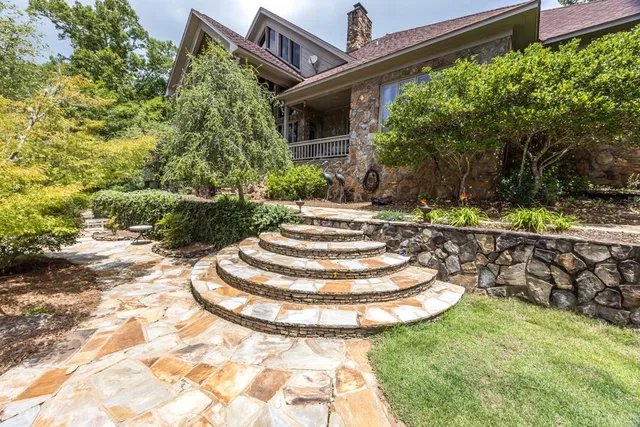 a bedroom with a bed and lamp with the view of bathroom
