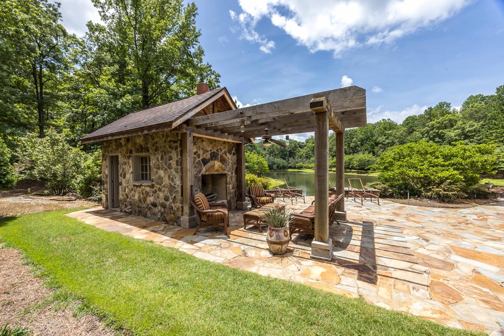 1140 Central Church Road Midland, GA 31820 - Photo 39 of 74 a view of a patio with table and chairs with wooden floor and fence