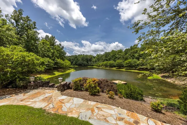 a view of a house with backyard and sitting area