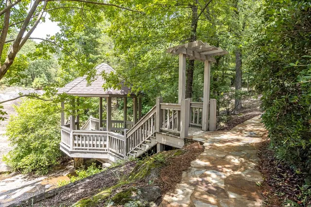 a bathroom with a granite countertop sink and a toilet