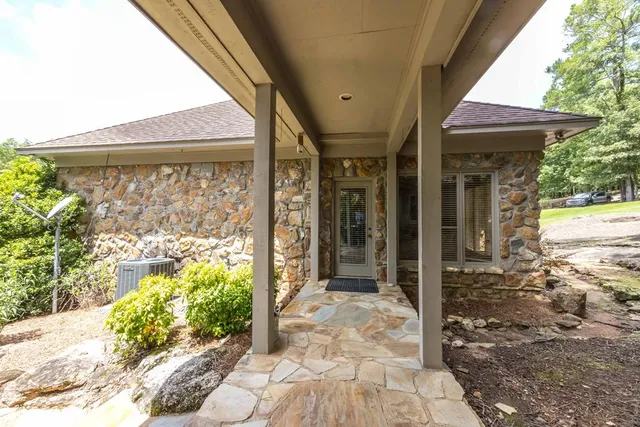a view of patio with chairs and wooden fence