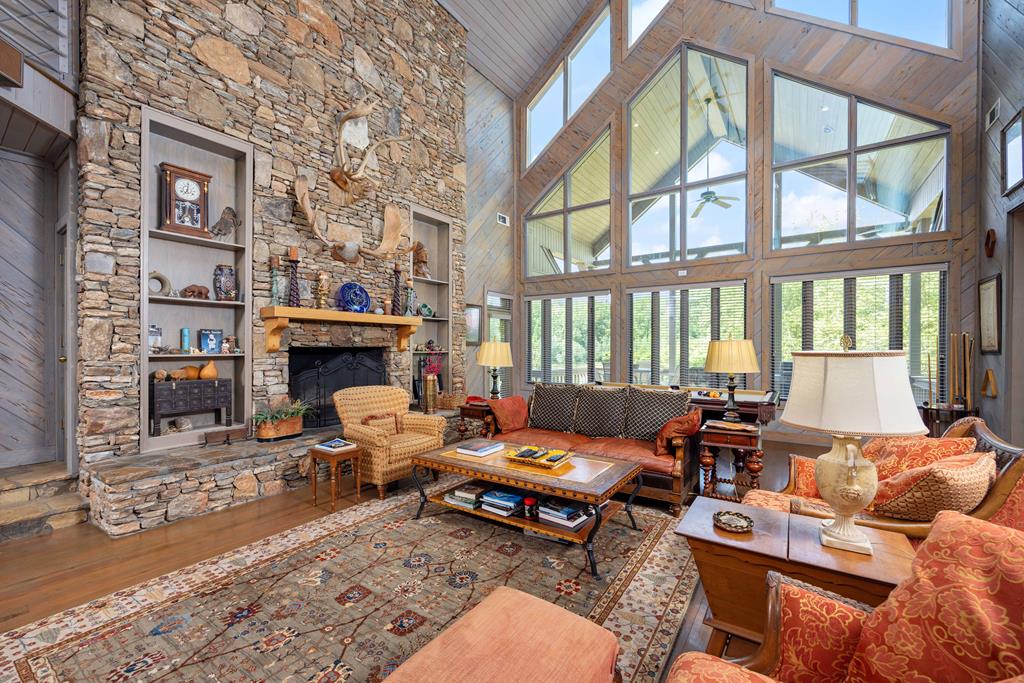 1140 Central Church Road Midland, GA 31820 - Photo 6 of 74 a living room with furniture a fireplace and a floor to ceiling window