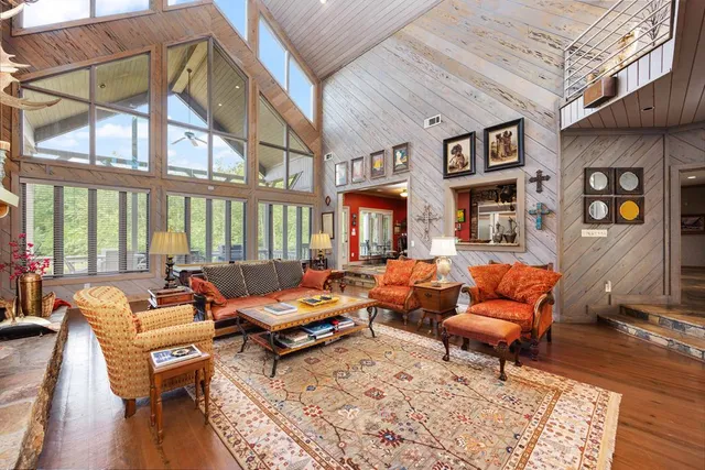 a living room with furniture a bed and a chandelier