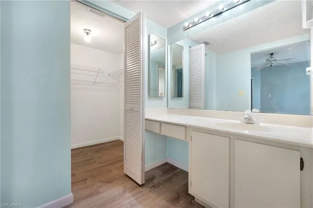 a bathroom with a double vanity sink and mirror