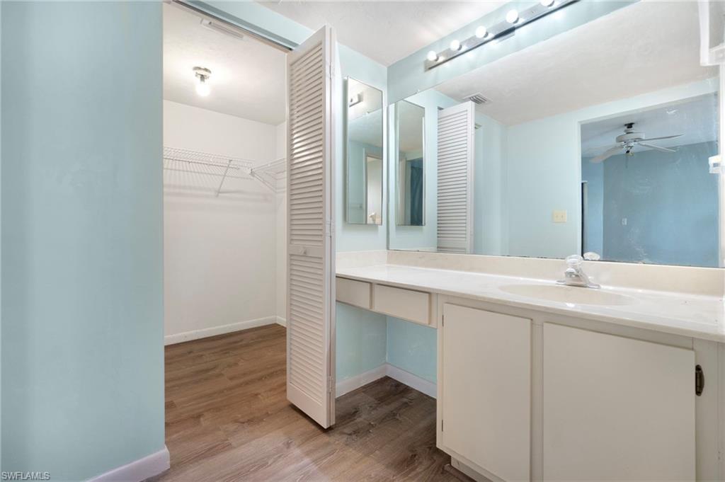 1814 Kings Lake Boulevard, Unit 201 Naples, FL 34112 - Photo 11 of 18 a bathroom with a double vanity sink and mirror