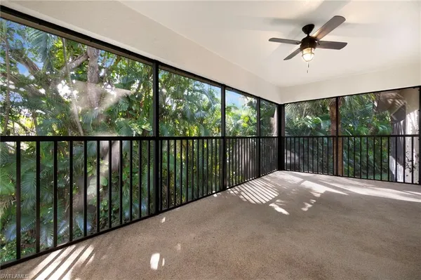 a balcony view with hardwood floor & a ceiling fan
