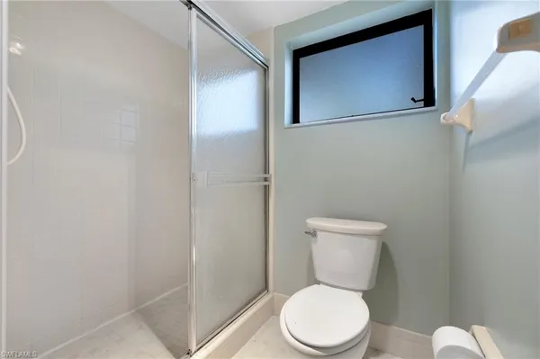 a white toilet sitting next to a bathroom sink