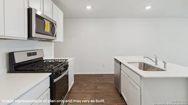 a kitchen that has a sink and a stove