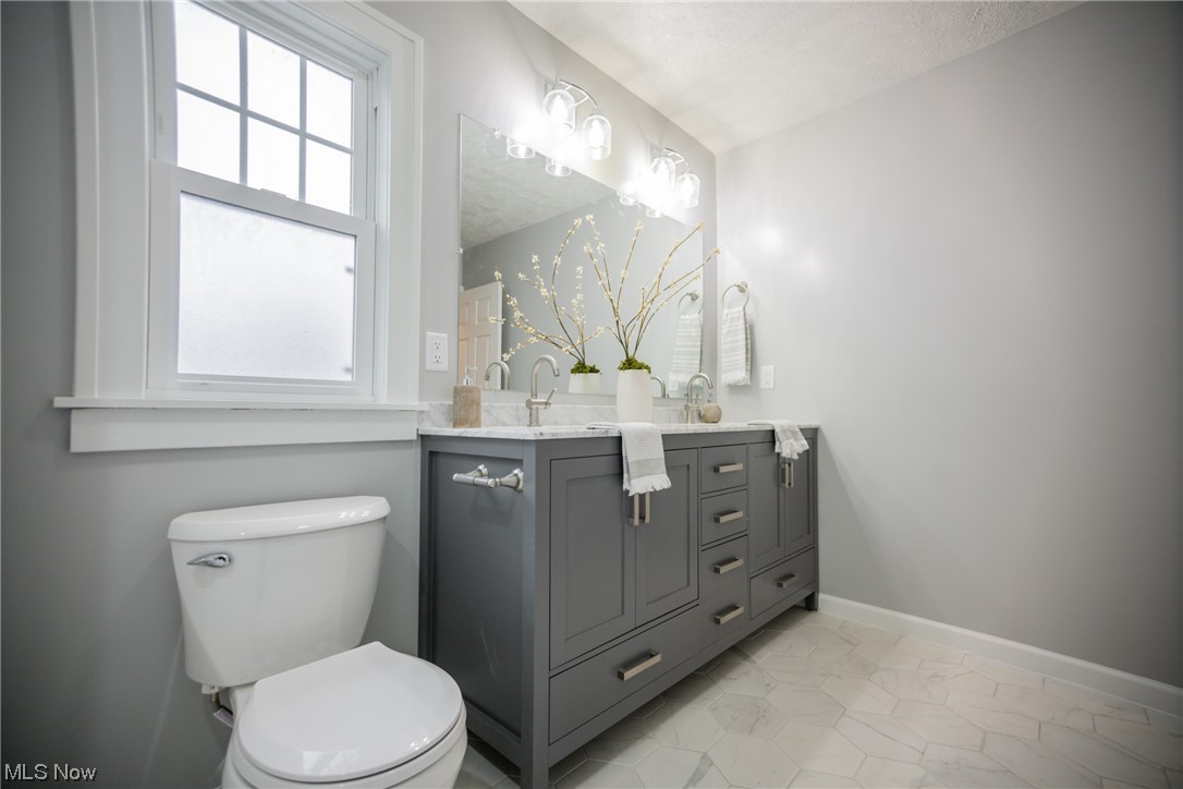3553 Avalon Road Cleveland, OH 44120 - Photo 18 of 39 Bathroom with plenty of natural light, toilet, tile floors, and large vanity