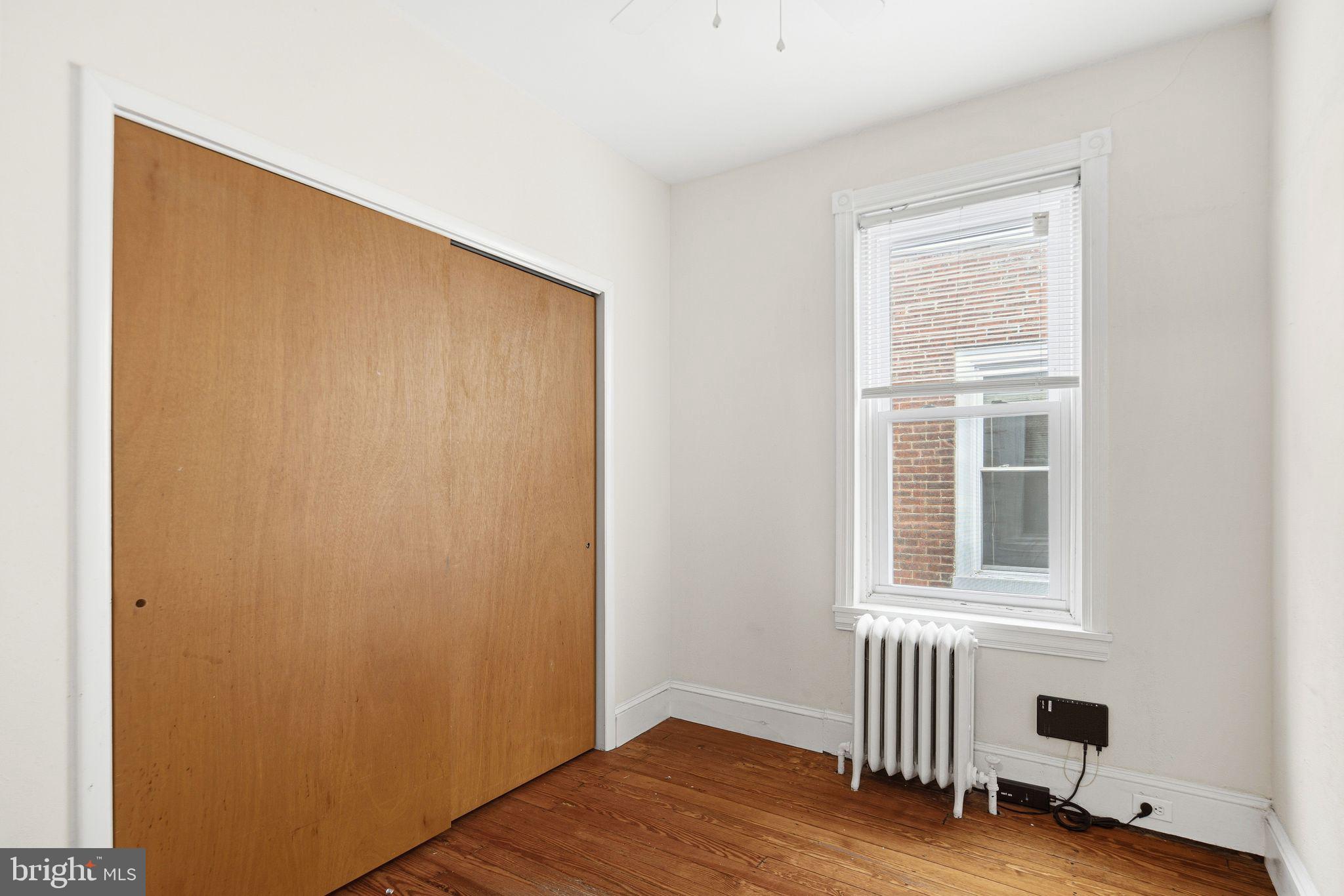 542 Martin Street Philadelphia, PA 19128 - Photo 12 of 16 an empty room with wooden floor and windows
